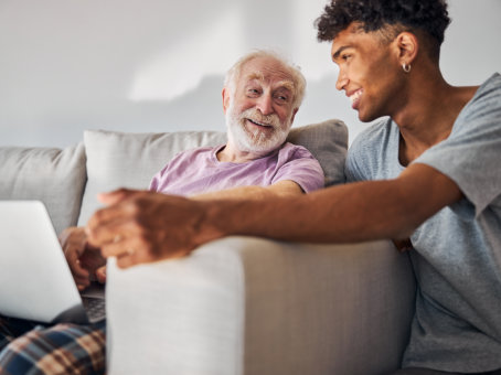 carer and senior man laughing