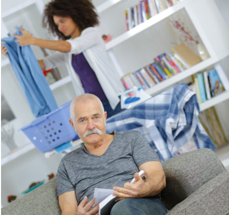 caregiver folding clothes while elderly sitting in front