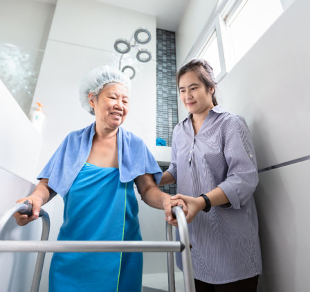 caregiver assissting senior in taking a bath