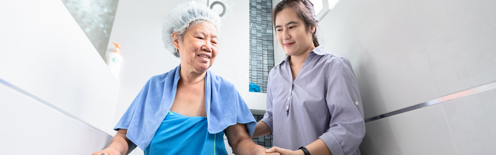 woman assisting the elderly in bathing