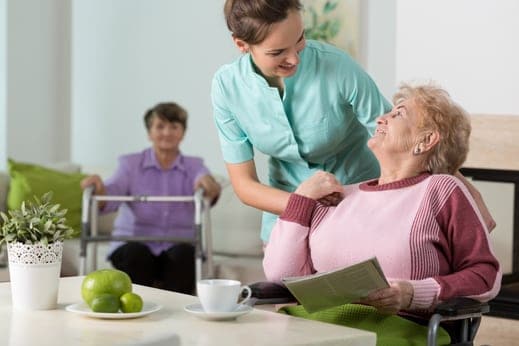senior woman with carer smiling at each other