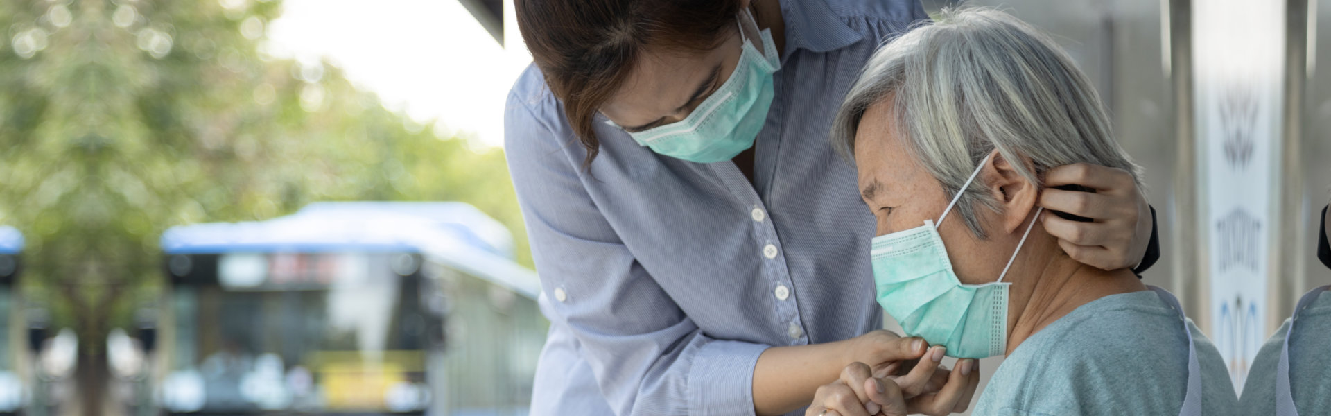 woman assisting the elderly wearing mask