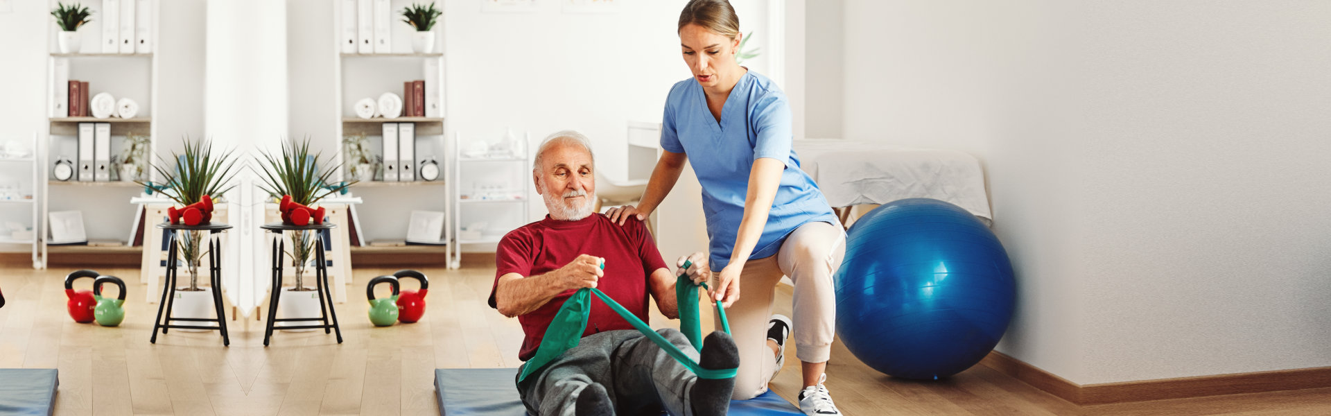 caregiver assisting elderly in exercising