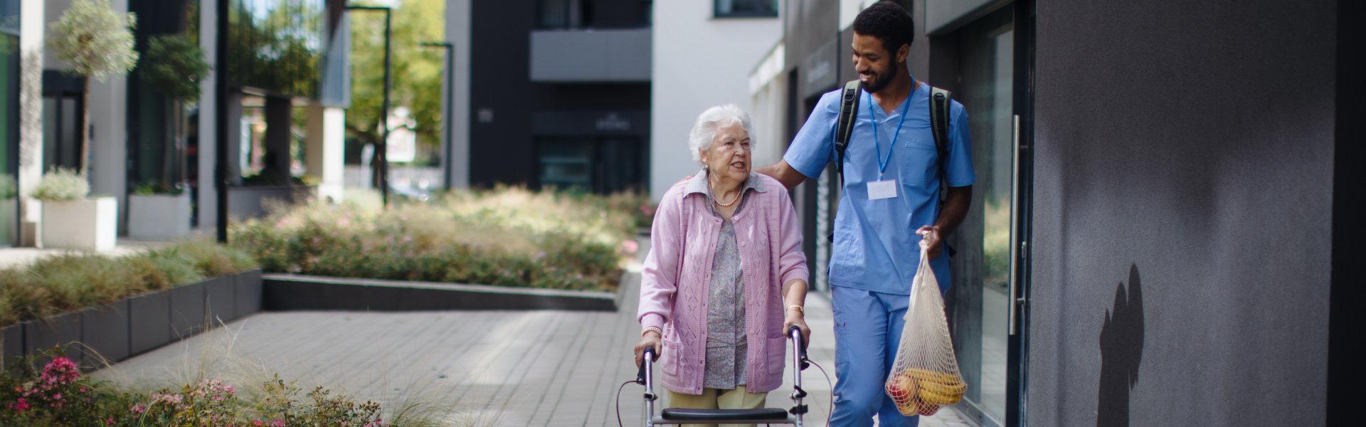 man caregiver and elderly walking