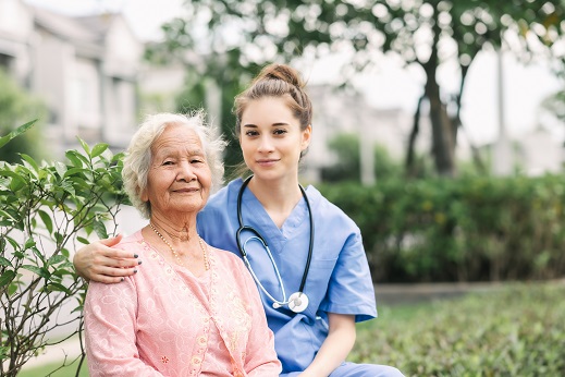 nurse and elderly woman outdoors