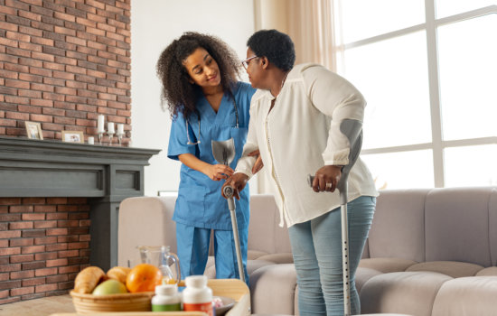 nurse assisting senior woman