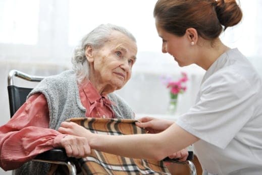 carer assisting senior woman