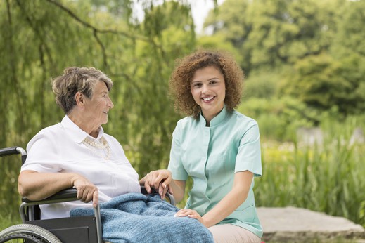 carer and elderly woman outdoors